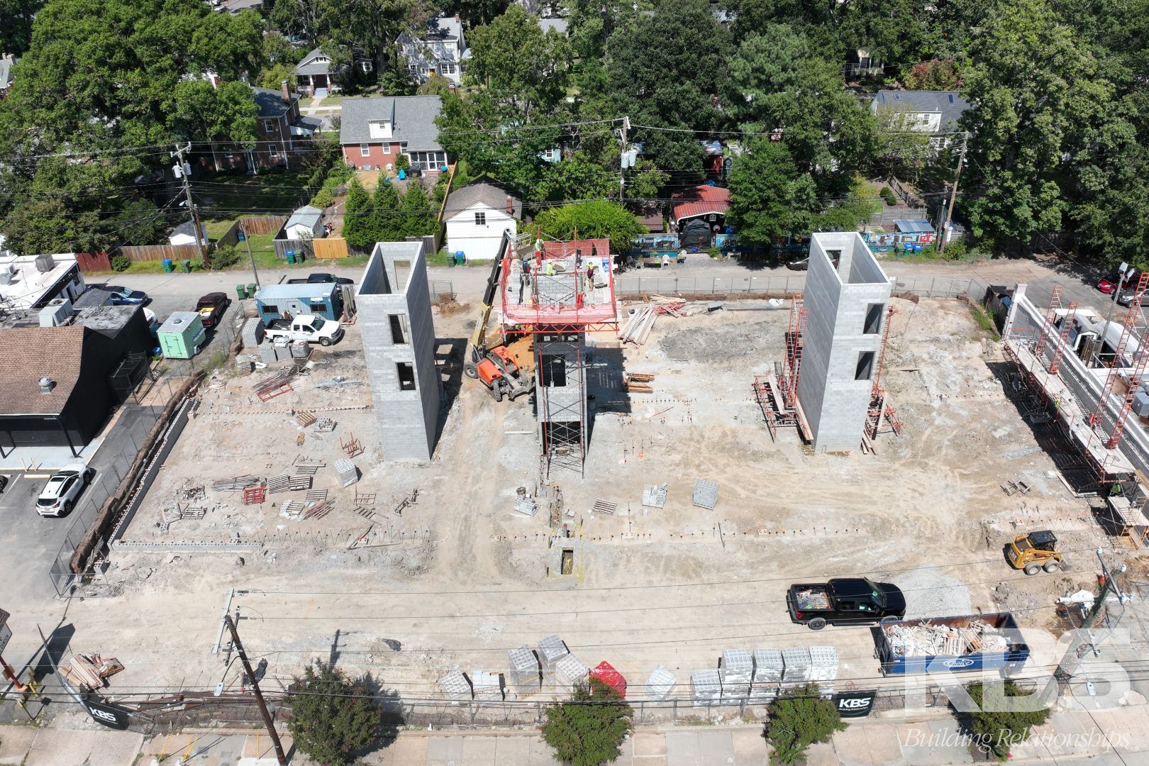 Aerial view of the construction site with the Westover Hills tree canopy beyond