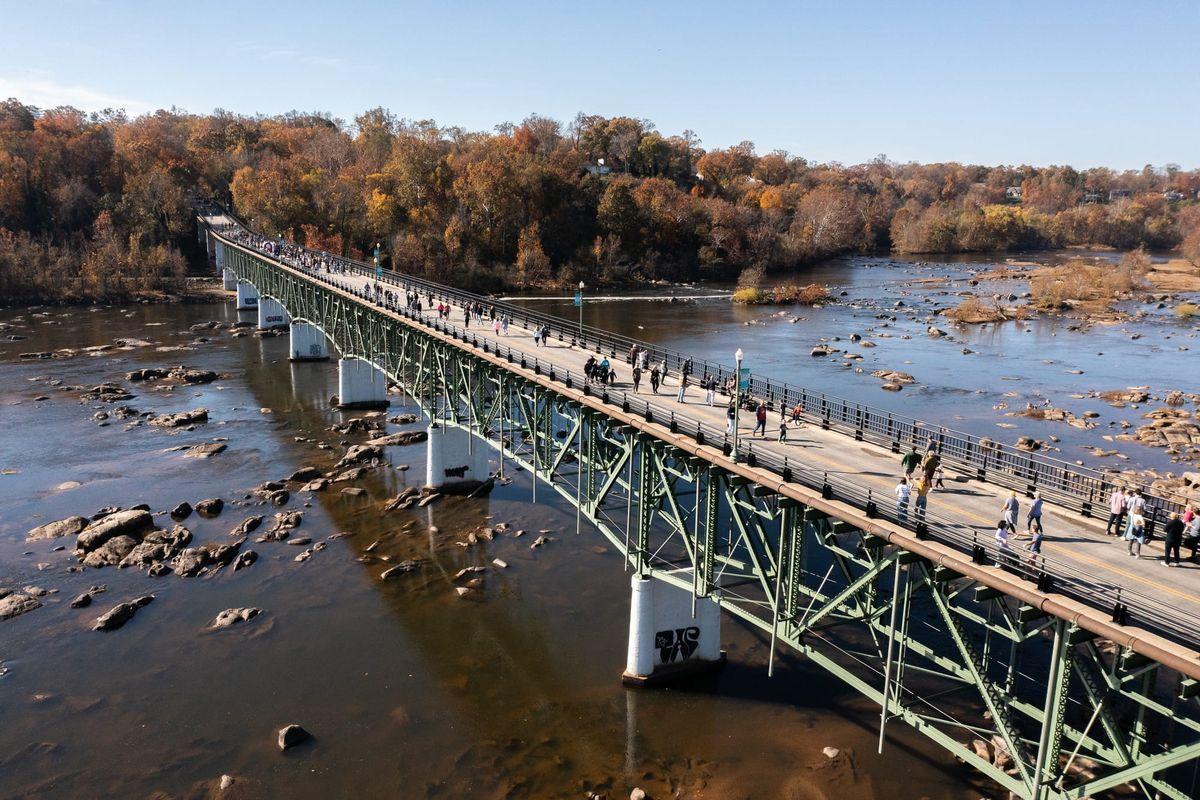 Aerial view of the Nickel Bridge over the James River with walkers on the pedestrian path